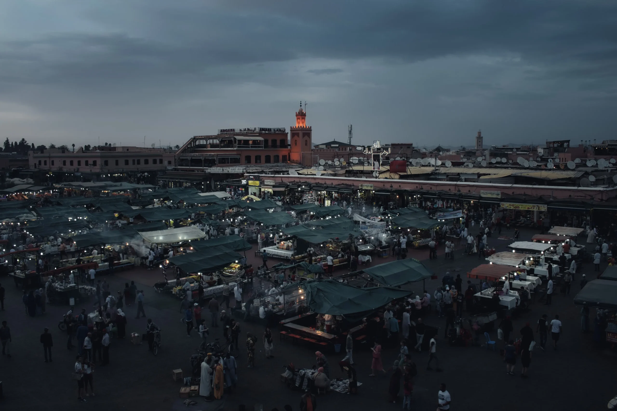 Casablanca vs Marrakech 2026: The Ultimate Guide to Morocco's Best Cities 3 Jemaa el-Fnaa square in Marrakech at dusk with food stalls and a lit minaret, a key stop when comparing Casablanca vs Marrakech