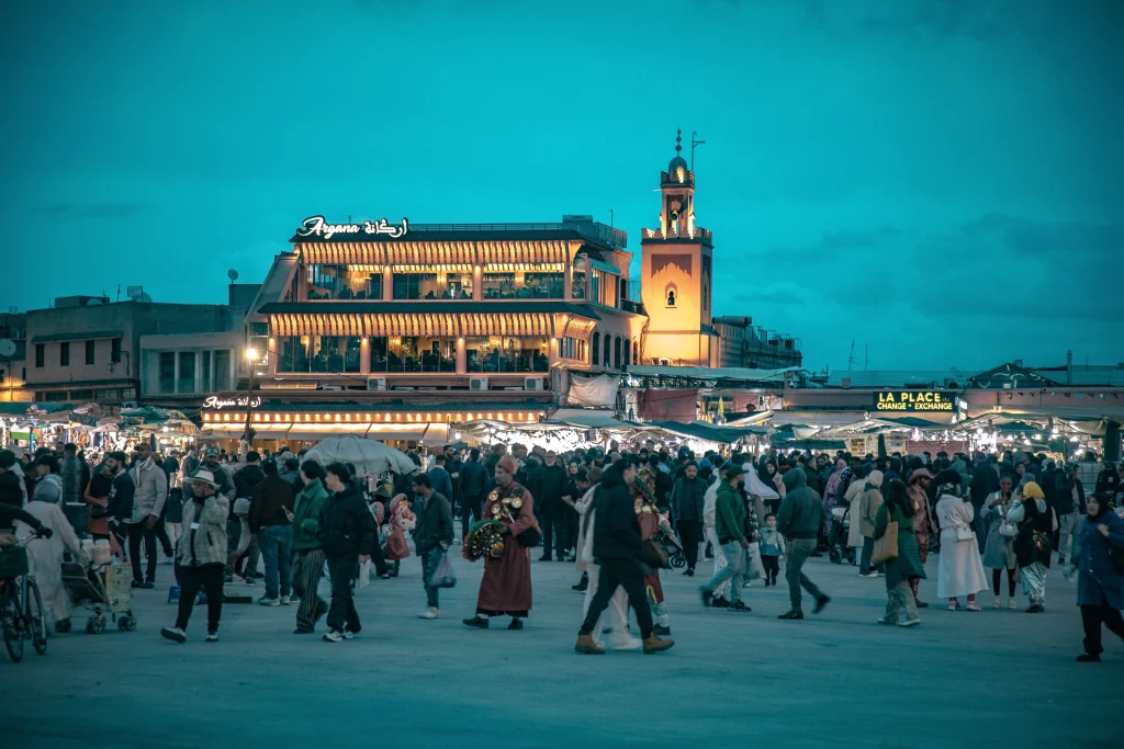 Casablanca vs Marrakech 2026: The Ultimate Guide to Morocco's Best Cities 1 Jemaa el-Fnaa square in Marrakech at dusk with the Argana restaurant and a lit minaret, a highlight in the Casablanca vs Marrakech comparison