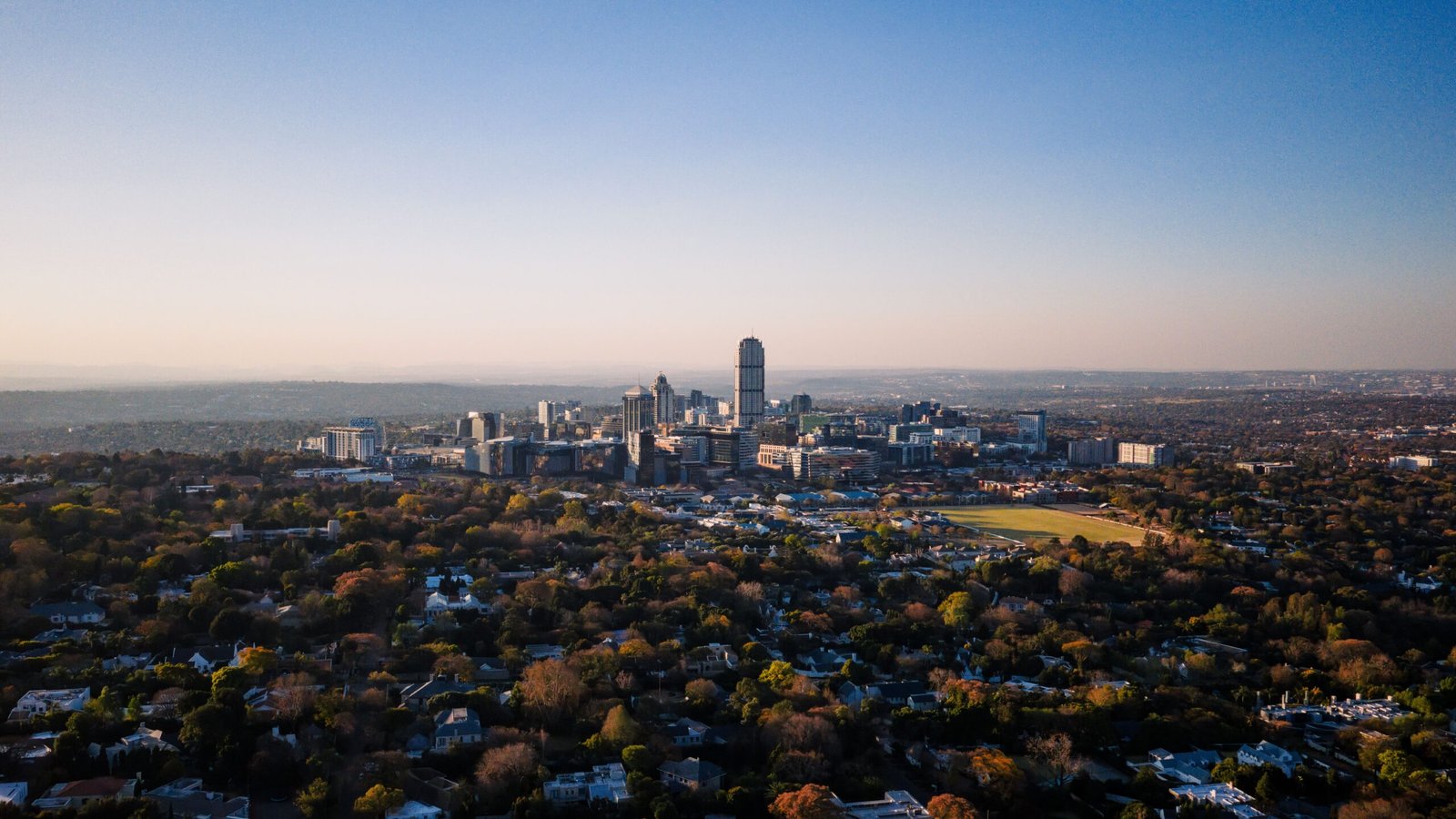 Johannesburg Street Food: What to Eat and Where to Find It (2026) 2 Aerial view of Johannesburg's Sandton skyline rising from the city's urban forest